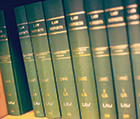 Set of green law books o a bookshelf